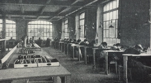Picture from Women Workers in an Etching Room in Gallé's Glass Manufactory in Nancy, late 19th or early 20th Century.. The Workers are Sitting at Tables Aligned Along the Wall with wide Factory Windows in Front of them